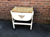 a white table with a bee on it
