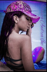 a girl in a bikini wearing a purple hat