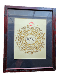 a framed piece of chinese calligraphy in a wooden frame