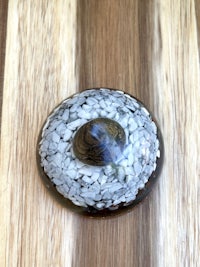 a black and white glass sphere on a wooden table