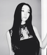 a black and white photo of a woman with long black hair