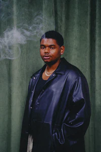 the man is wearing a black leather jacket