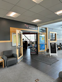 the lobby of a building with a desk and chairs