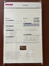 a sign hanging on a wall with information on it