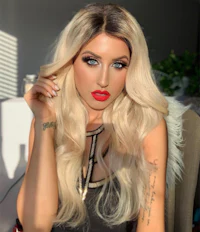 a woman with long blonde hair posing for a photo