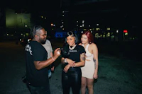 a group of people standing next to each other at night