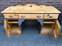 a wooden desk with drawers and drawers