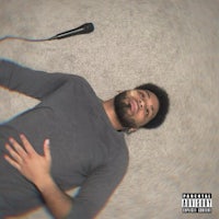 a man with a beard is looking up at the camera