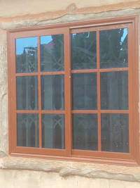 a brown window with a wooden frame in a house