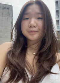 a woman with long brown hair is taking a selfie