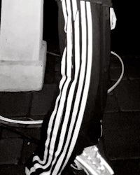 black and white photo of a person holding a skateboard