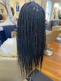 a black braided wig in a salon