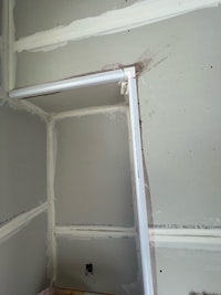 a room that is being remodeled with drywall and a door