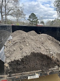 a large pile of dirt in the back of a truck