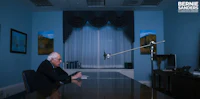 bernie sanders sitting at a desk in an office