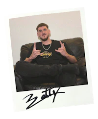 a man sitting on a couch with his hands in the air