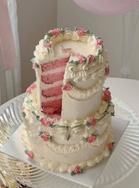 a pink cake with a slice taken out of it