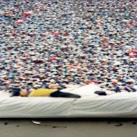 a person laying on top of a large pile of pillows