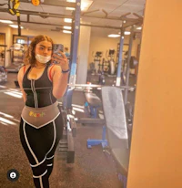 a woman taking a selfie in a gym