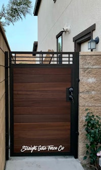 a wooden gate in front of a house