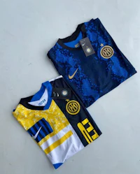 two nike inter milan jerseys on a white surface