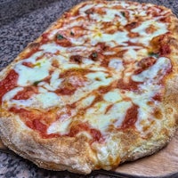 a pizza on a wooden cutting board