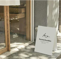 a sign outside of a shop with a door