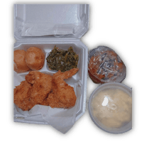 a tray with fried chicken, biscuits and gravy