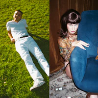 a man and woman laying on the grass