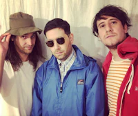 three men in hats and jackets posing for a picture