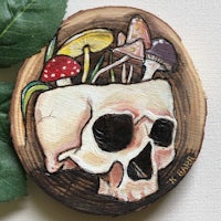 a painting of a skull with mushrooms and leaves on a piece of wood