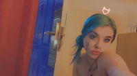 a girl with blue hair is taking a selfie