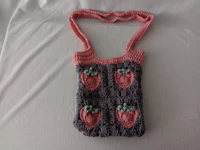 a crocheted bag with strawberries on it