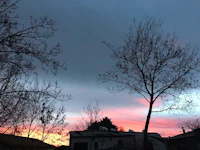 sunset over a rv with trees in the background