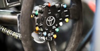 a close up of the steering wheel of a racing car