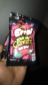 a person holding a bag of eri's sour candy