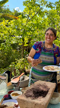 a man and woman standing next to a plate of food