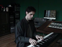 a man playing an electronic keyboard in a room