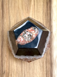 a piece of agate on a wooden surface