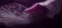 a hand holding a card in front of a dark background