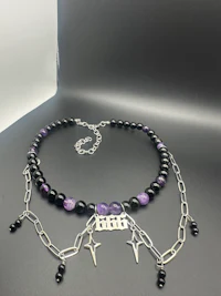 a purple and black beaded choker with a silver chain