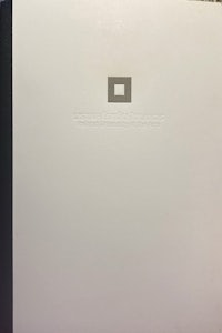 a white book with a black cover on it