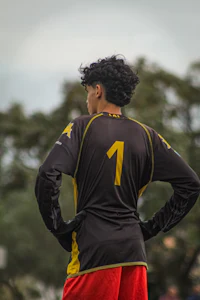 a man wearing a yellow and black uniform