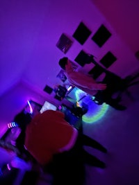 a group of people playing video games in a dark room