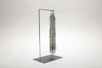 a black stand with a feather on it