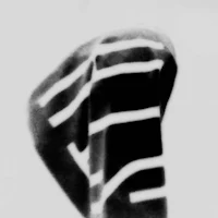 a black and white photo of a hat with stripes on it
