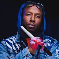 a man in a blue hoodie holding a knife