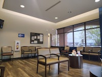 a waiting room with chairs and a television