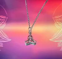 a silver necklace with a meditating buddha on it
