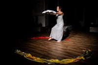 a woman in a white dress standing in a circle